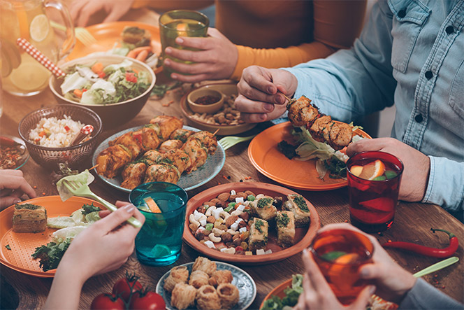 A farm table with people gathered to share food